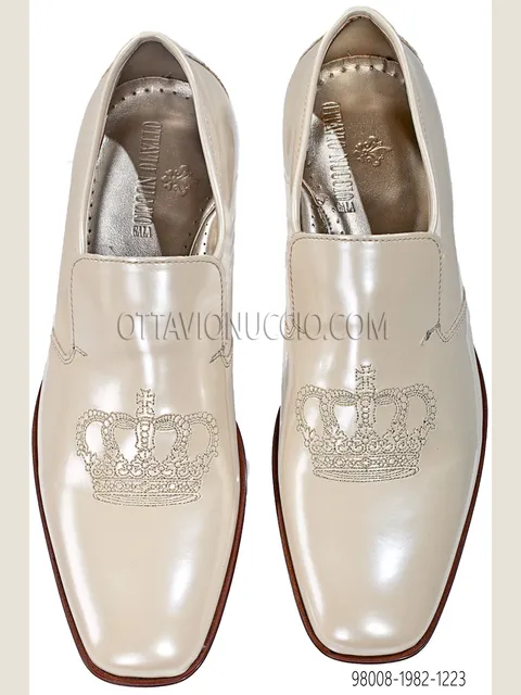 Ivory slipper with gold crown embroidery