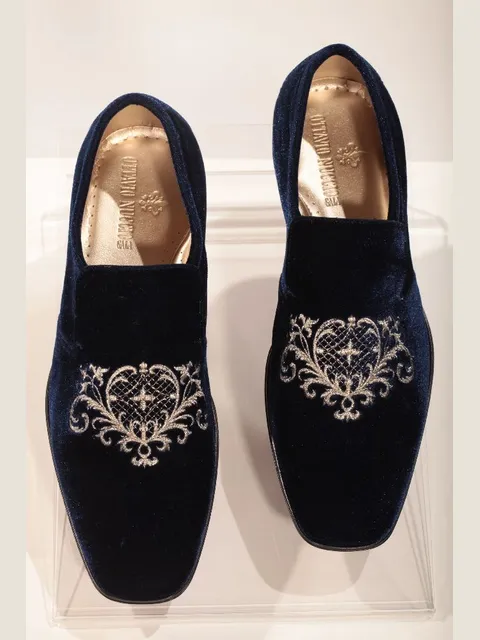 Blue velvet slippers with gold tone shield embroidery
