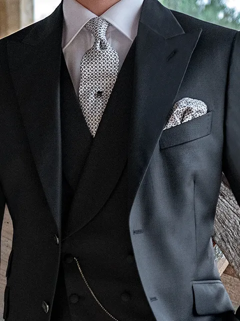 Double-breasted waistcoat with shawl lapel in black wool with covered buttons