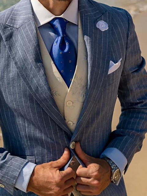 Waistcoat in white linen with light blue floral embroidery