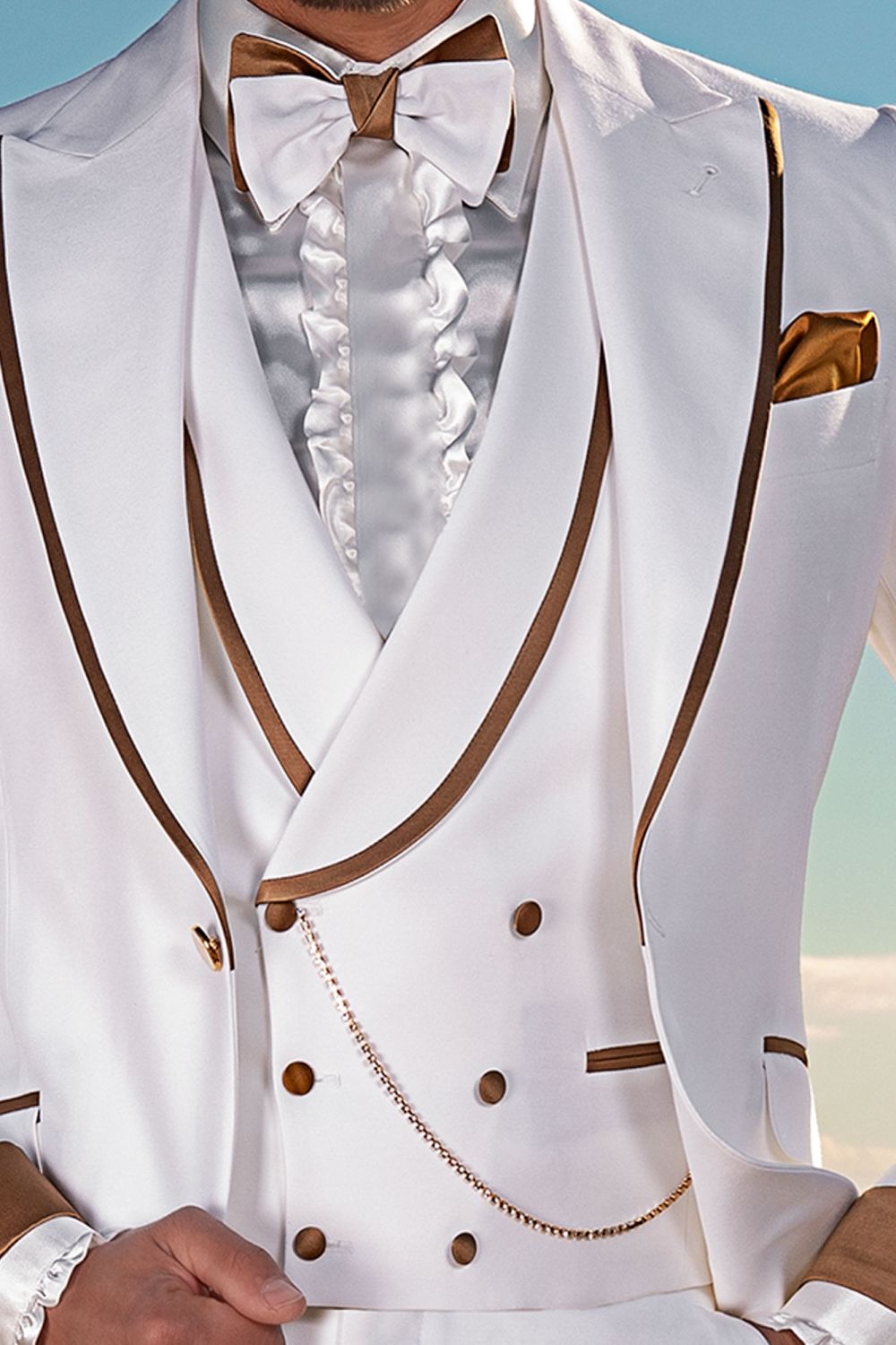 white suit with gold bow tie